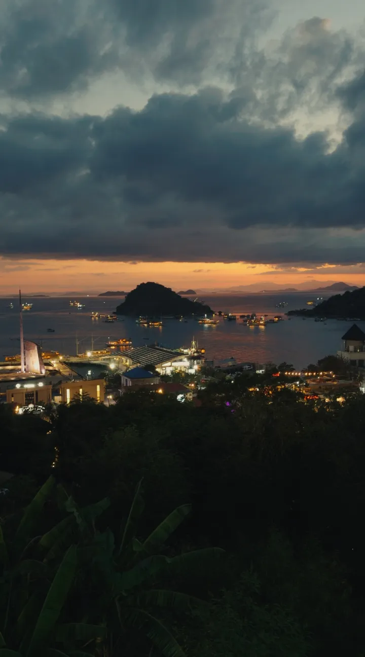 A harbour town under heavy clouds at dusk.